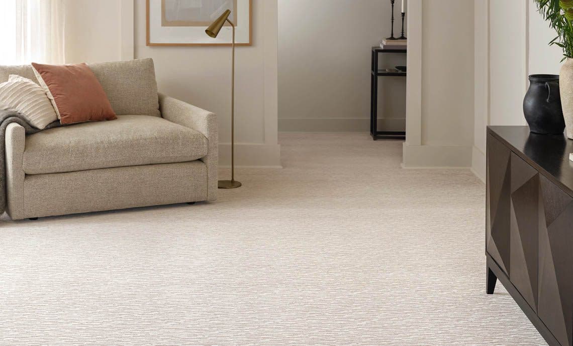 Soft neutral carpet running through a light, furnished living room