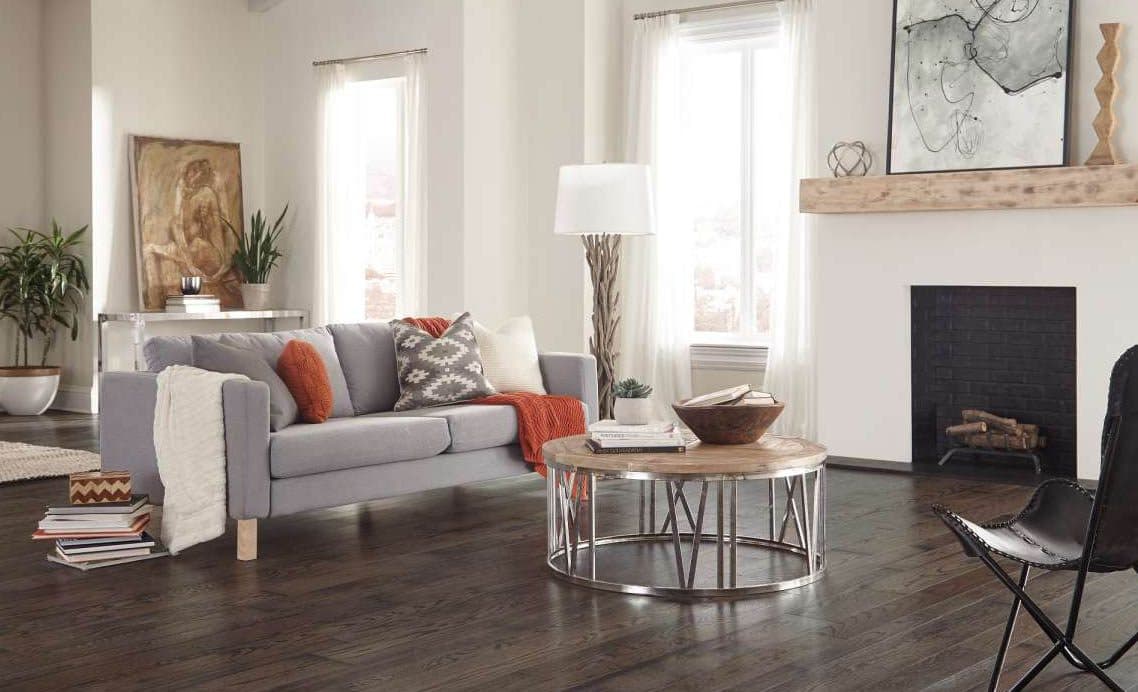 Refinished dark hardwood flooring in a furnished living room